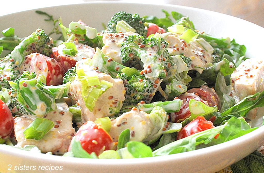 A chicken salad served in a white bowl.