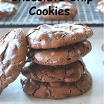 A pile of chocolate cookies set on a table.