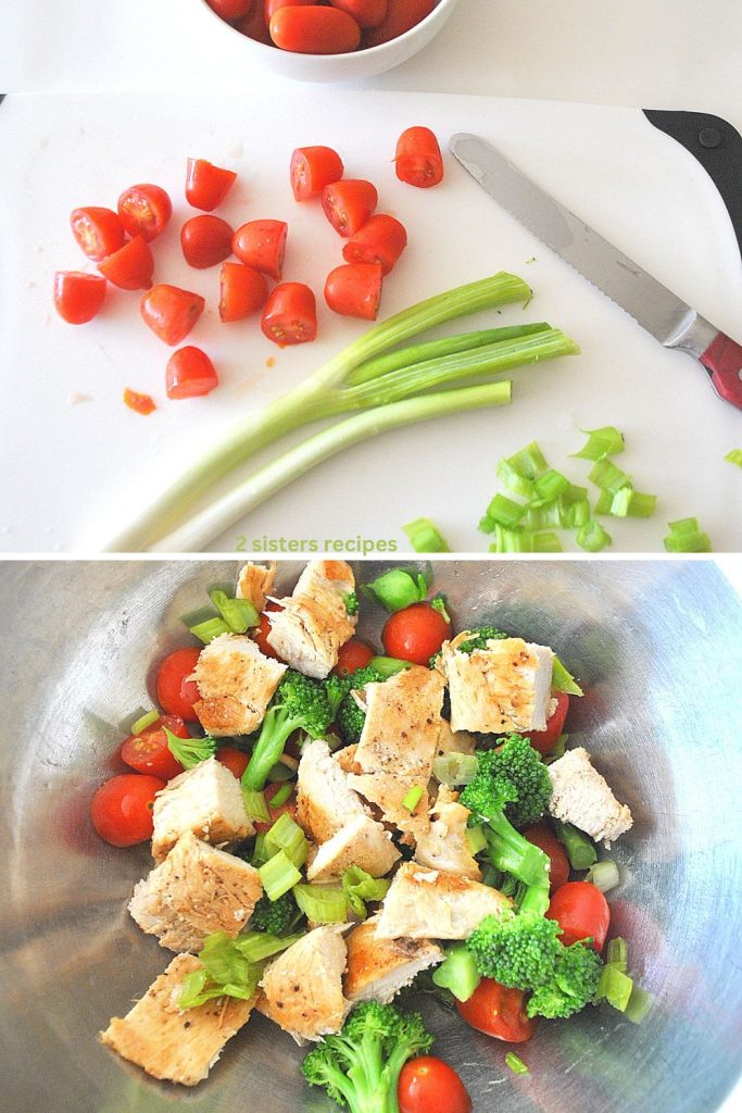 A white board with cherry tomatoes and green onions sliced, and a silver bowl with pieces of cooked chicken, tomatoes and green onions.