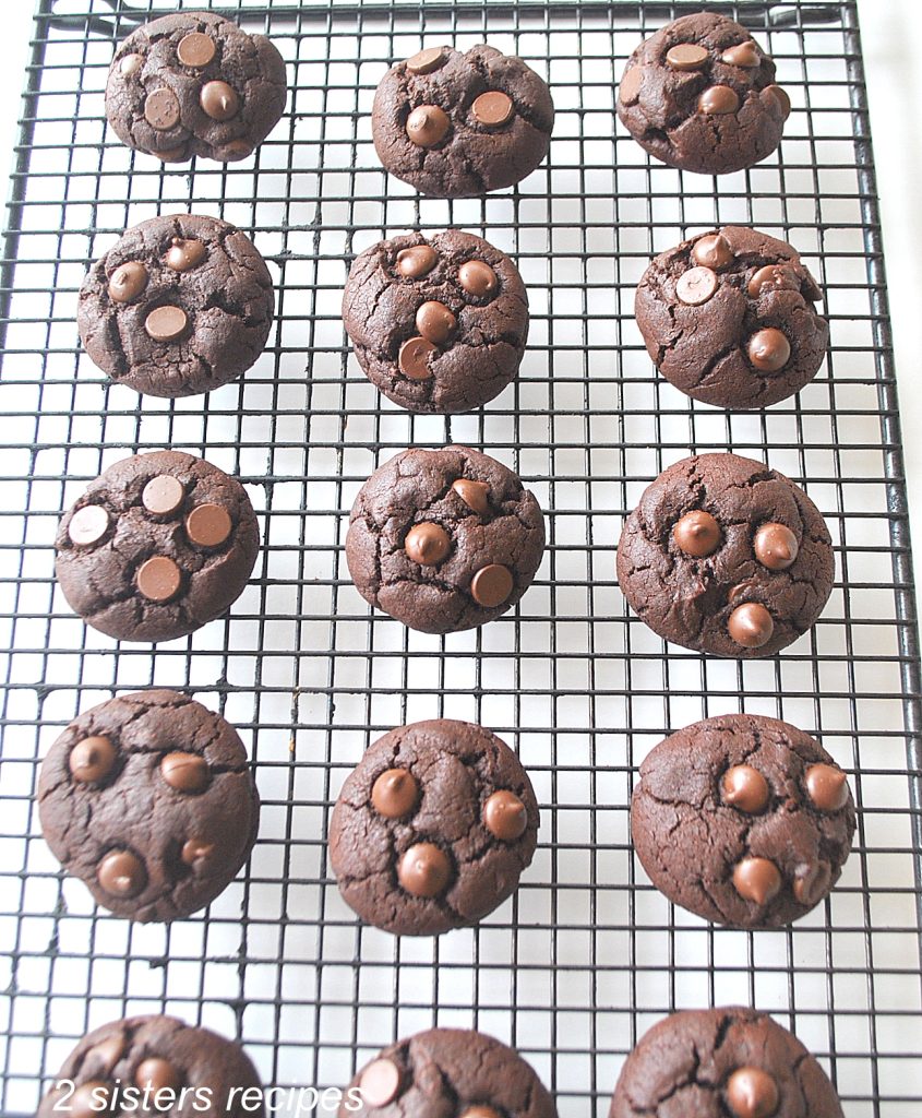 A wire rack with brownie cookies cooling on it.  by 2sistersrecipes.com