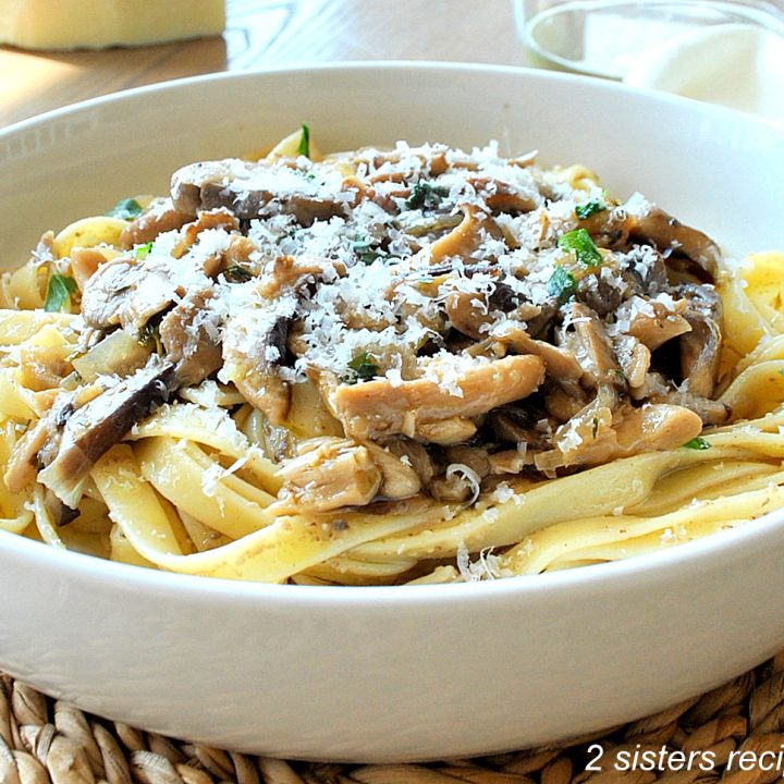 A white bowl filled with wide pasta topped with a wild mushroom ragu.