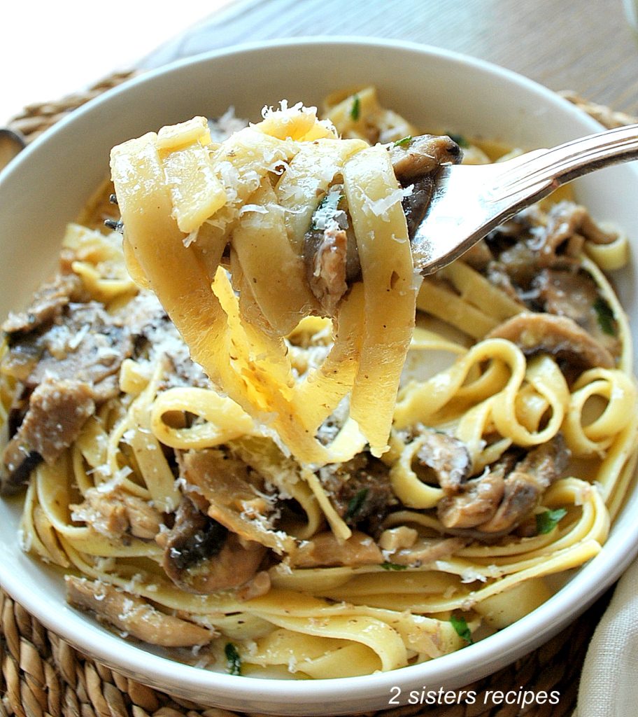 A forkful of fettuccine pasta and mushroom ragu. by 2sistersrecipes.com