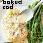 Spooning some lemon-Dijon sauce over the baked cod, with asparagus on the side.