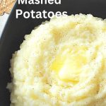 A black square bowl filled with mashed potatoes will some butter melting on top.