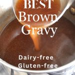 A pot filled with brown beef gravy and a ladle stirring it.