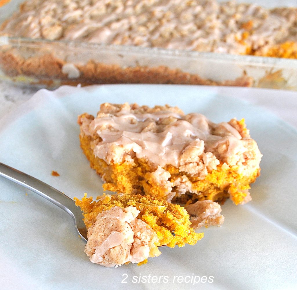 A forkful of pumpkin crumb cake on a plate. by 2sistersrecipes.com