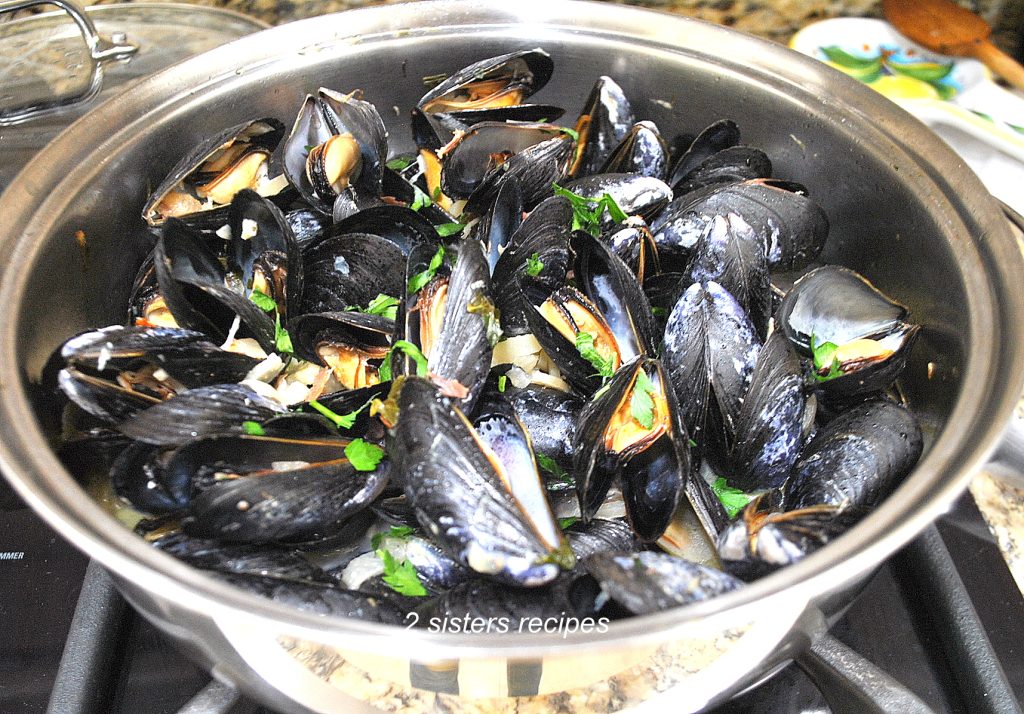 Steamed Mussels with garlic fennel broth in a large deep skillet.