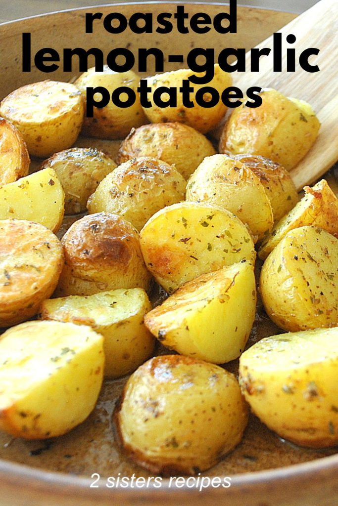 A baking dish with roasted crispy potatoes with a wooden spoon.   