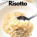 A white dish with cooked Arborio rice, cheese and black pepper.