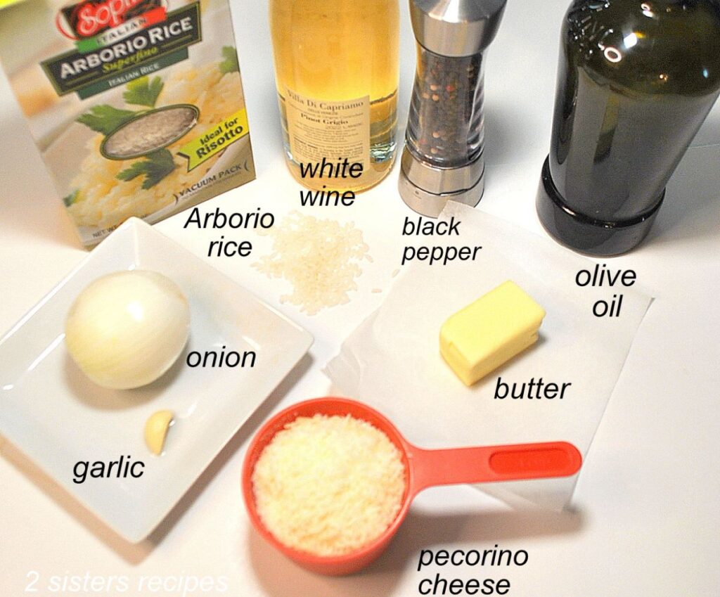 All the ingredients for cacio e pepe risotto are placed on a white board and labeled.