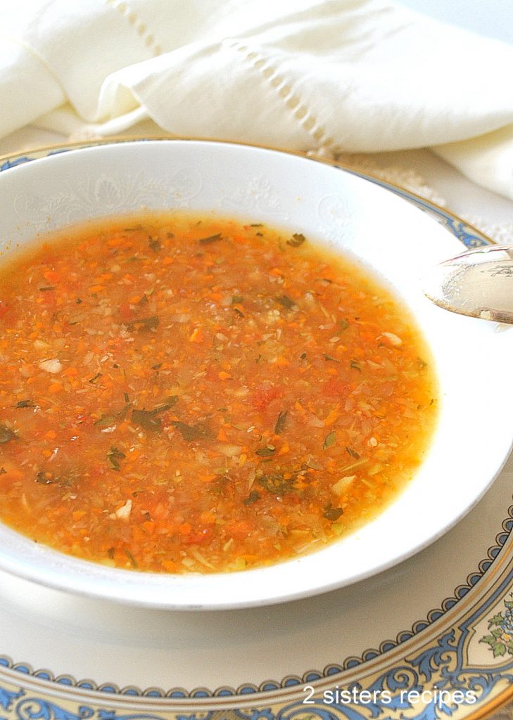 A white bowl with a serving of vegetable soup.