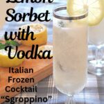 A tall fluted glass filled with lemon sorbet, and a lemon slice on top.