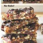A pile of fruit & nut protein bars on white parchment paper.
