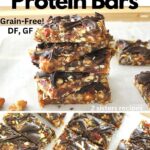A pile of fruit & nut protein bars on white parchment paper.