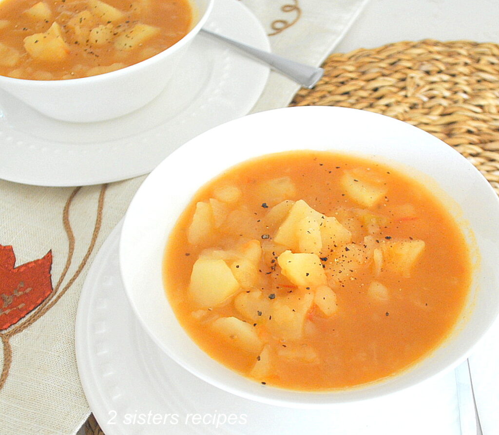 2 white soup bowls filled with mom's potato soup.