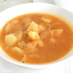 A white bowl filled with mom's potato soup.