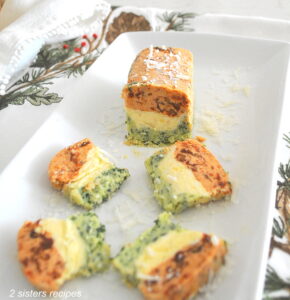 A white butter plate with a tri color butter terrine sliced .