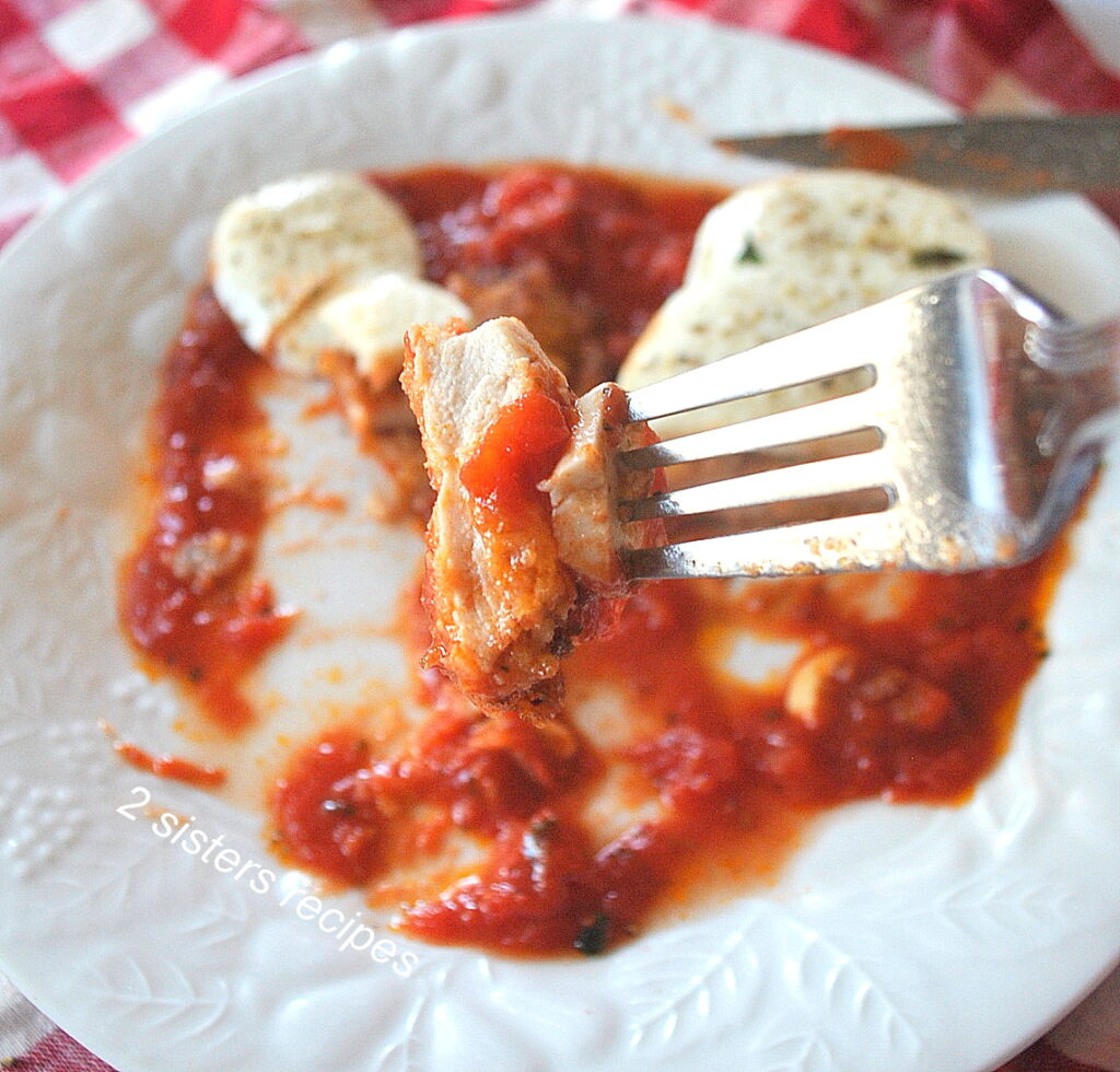 A forkful of crispy chicken, with some pizza sauce and fresh mozzarella.