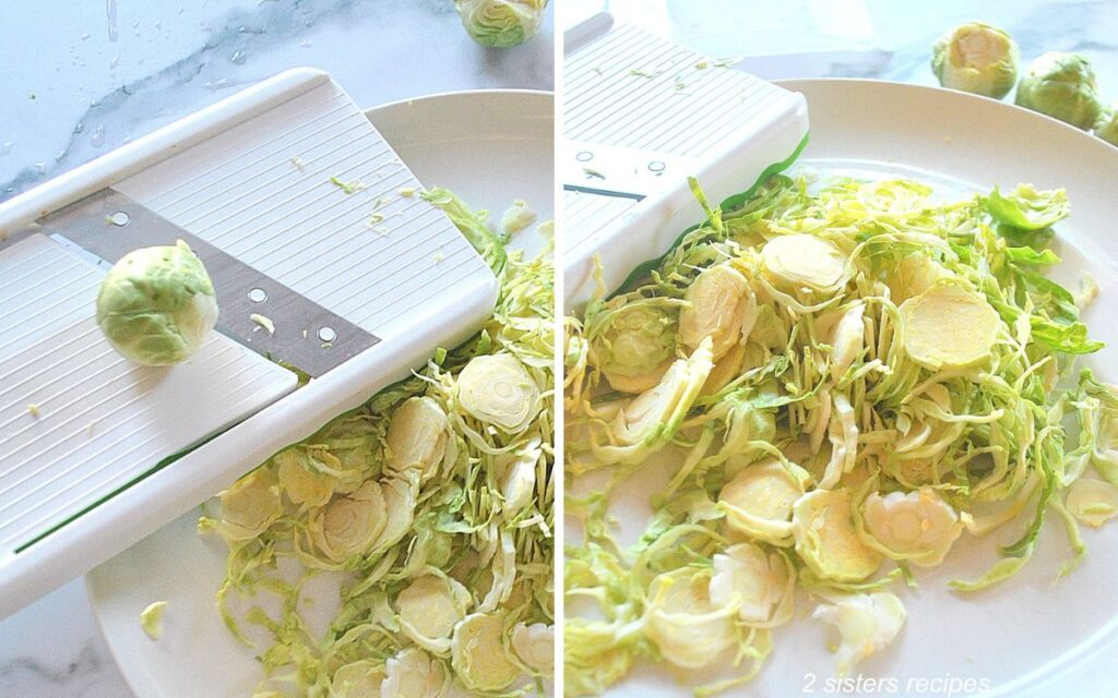 A vegetable mandolin slicer with one brussel sprout sitting on it. A white plate with a pile of shaved brussels sprouts.