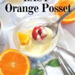 A spoonful of orange posset (pudding) with a raspberry on top.