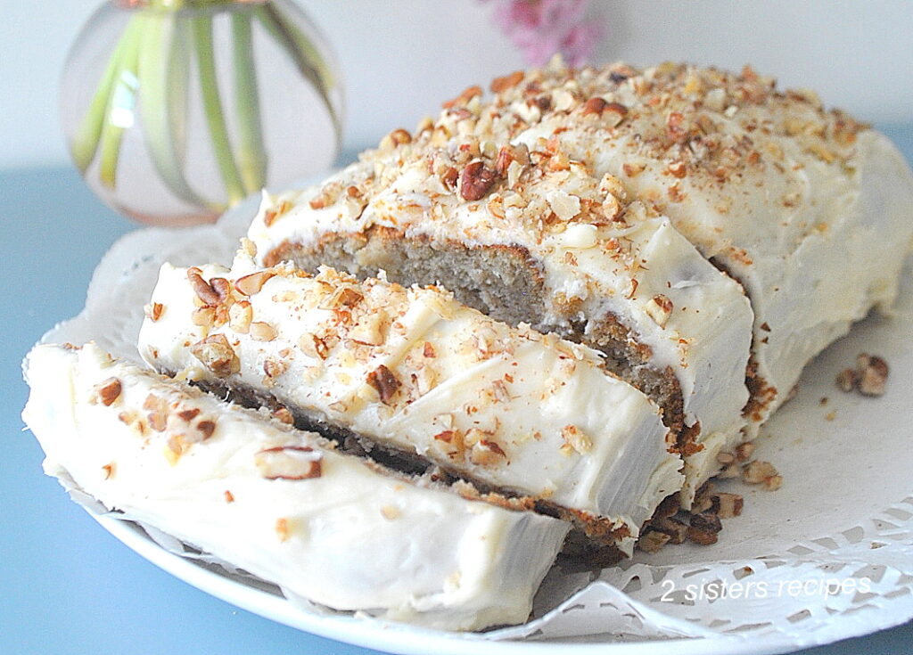 A hummingbird quick bread sliced on a white plate.