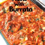 A casserole dish with tagliatella nests with burrata smothered in tomato sauce.