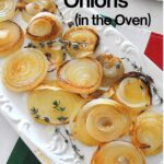 A white platter filled with caramelized onions with sprigs of thyme.
