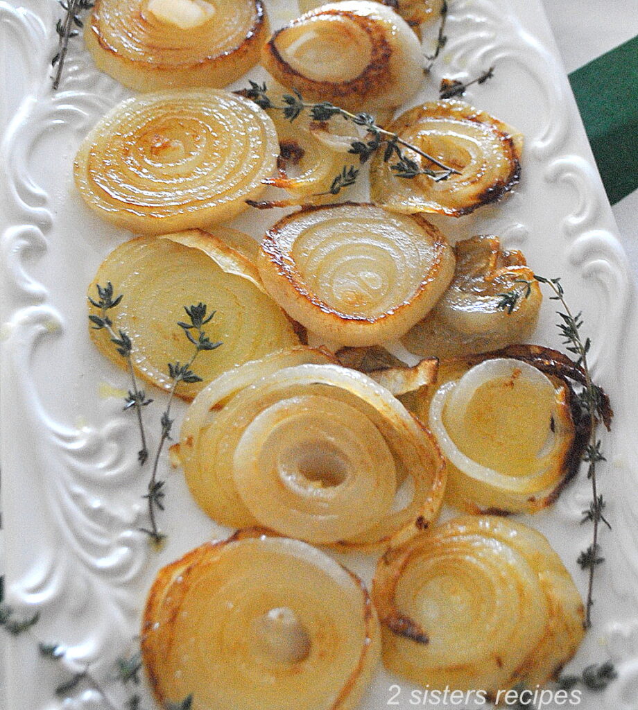 A white platter filled with caramelized onions.