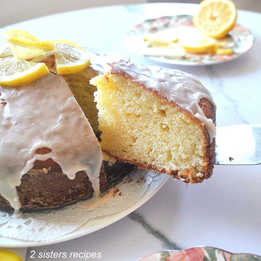A slice of lemon cake with icing on top.
