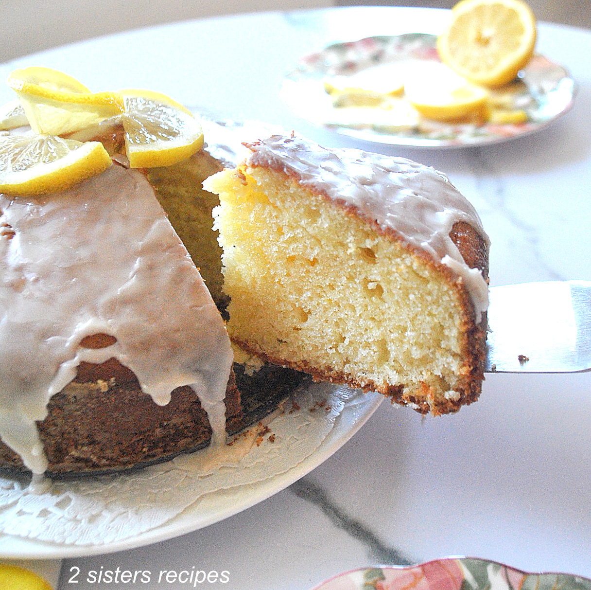A slice of lemon cake with icing on top.