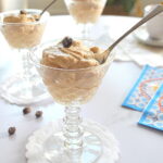 Three cordial glasses filled with a coffee cream and spoon.