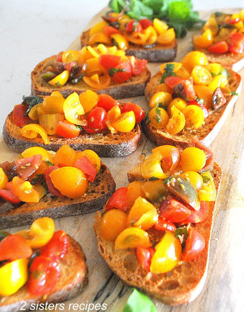 A charcuterie board with bruschetta al pomodoro displayed.