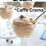 A cordial glass filled with a coffee cream and a spoon inside.