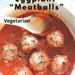 A Dutch oven filled with eggplant meatballs and tomato sauce with a wooden spoon.