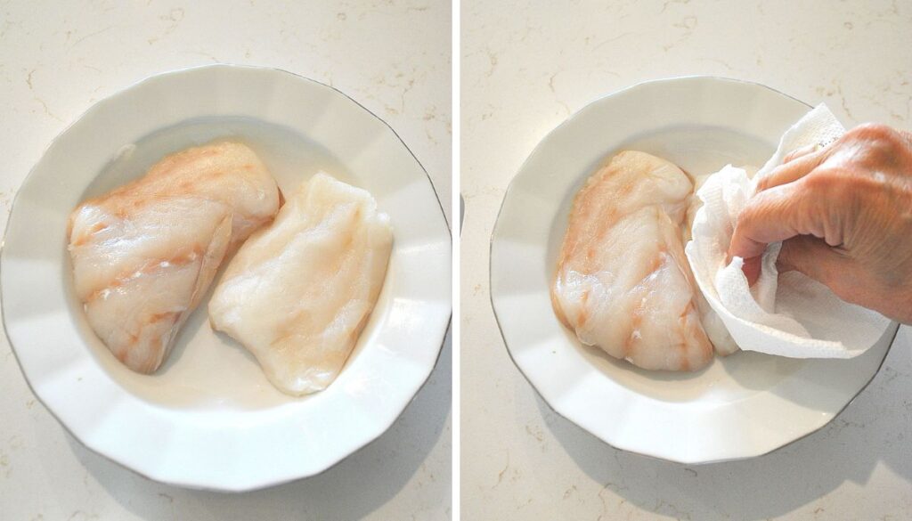 A white plate with raw cod fish.