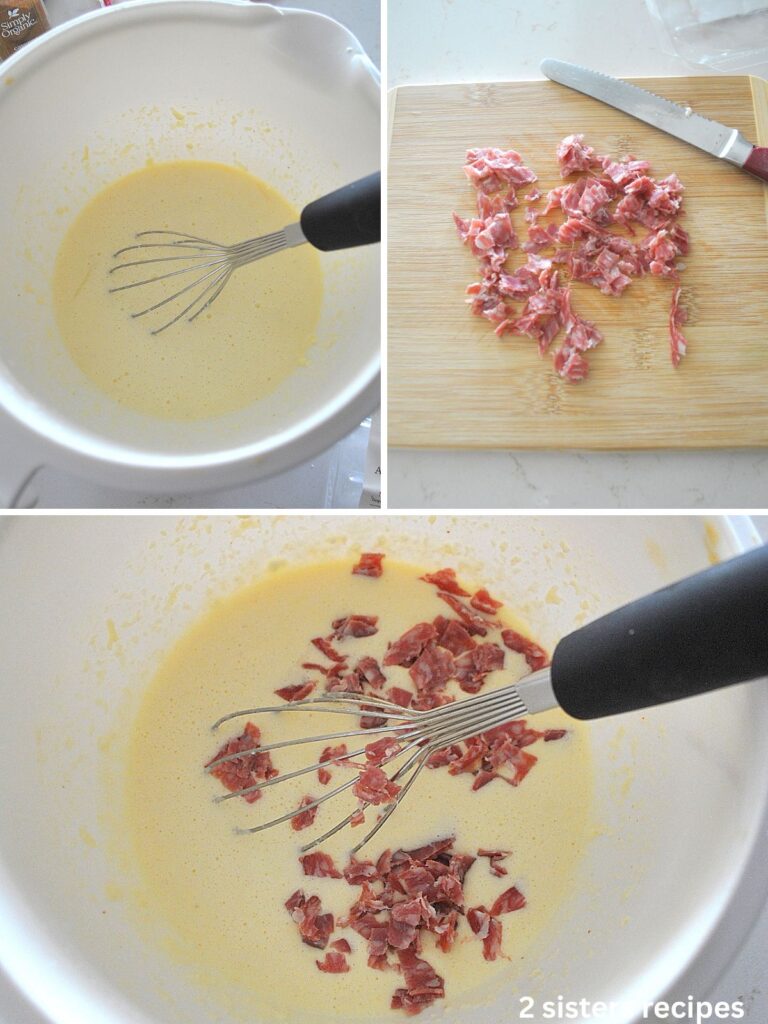 A white mixing bowl with batter, salami chopped on a wood board, and then whisked into the batter.