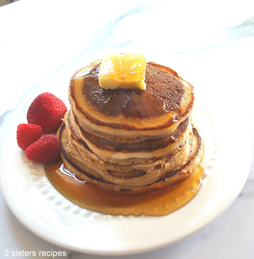 Maple syrup poured over the pancakes.