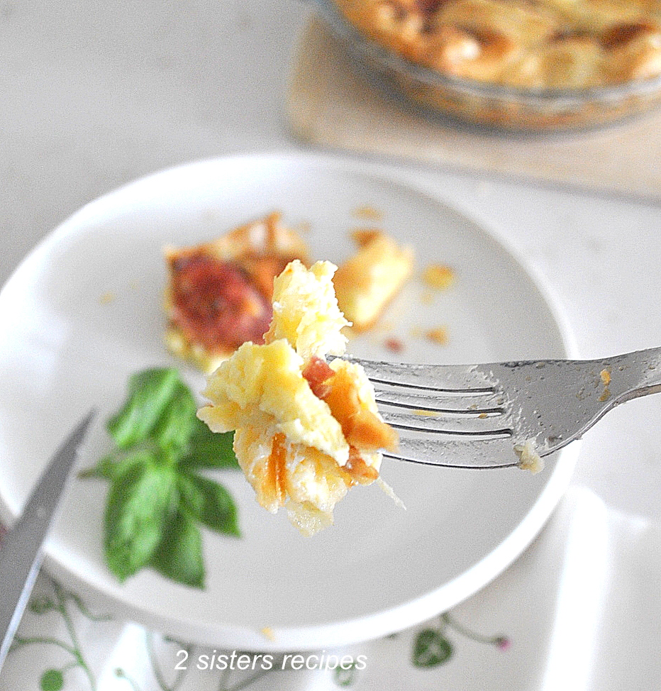 A forkful of the quiche with salami and gruyere cheese.
