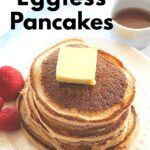 A pile of pancakes with a slice of butter on top.