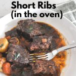 Three boneless short ribs in a white plate with some small potatoes, and carrots with a fork.