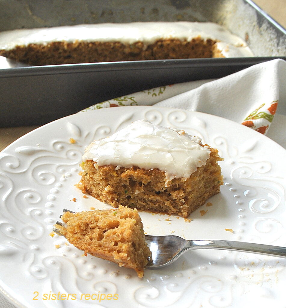 A slice of snack cake served on a white plate.