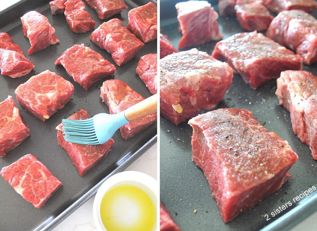 A baking sheet with raw short ribs, coating with olive oil, then with salt and pepper.