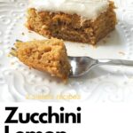 A slice of zucchini lemon snack cake with a fork on a white plate.
