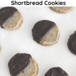 A baking sheet filled with baked espresso shortbread cookies dipped in chocolate.