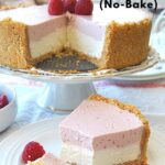 A slice of a two flavor cheesecake served on a white plate with fresh raspberries on the side.