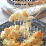 A forkful of potato and cheesy Gruyere Casserole over a blue dish.