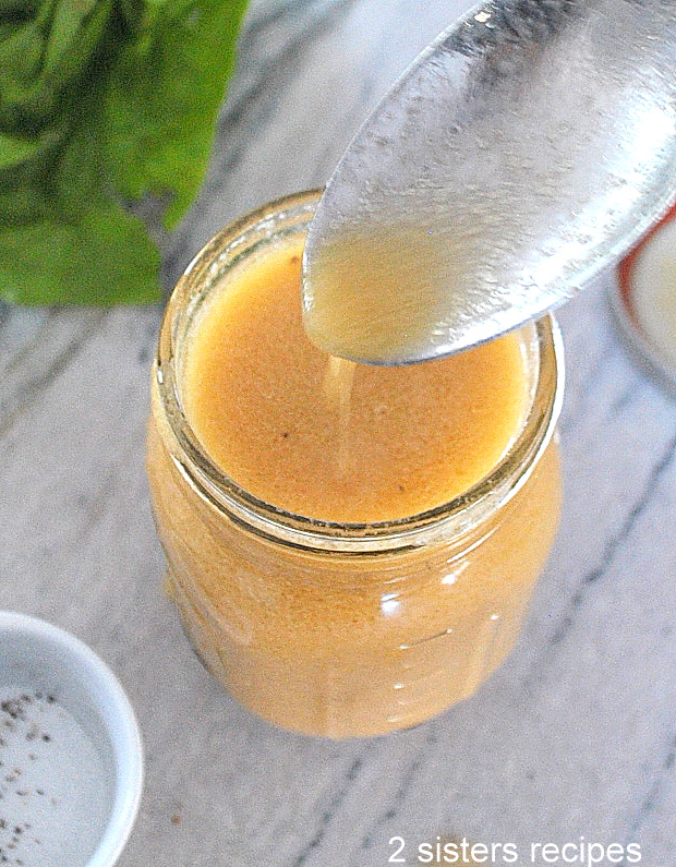 A spoonful of dressing from a mason jar.