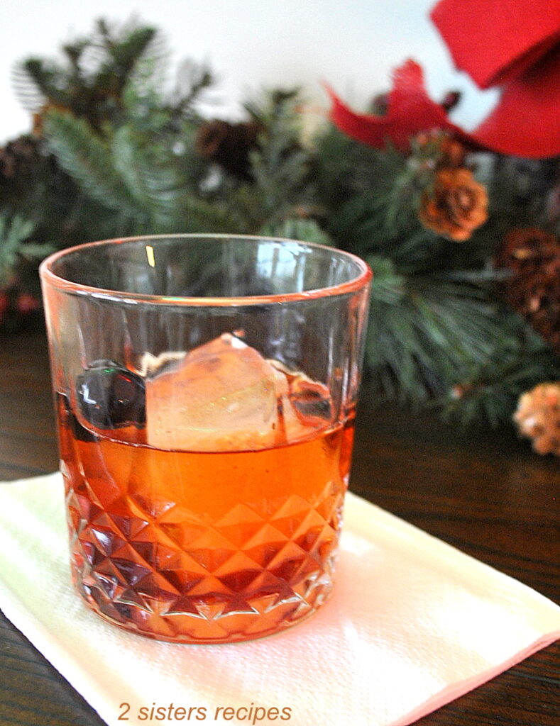 An Old Fashioned cocktail drink served on a white napkin.
