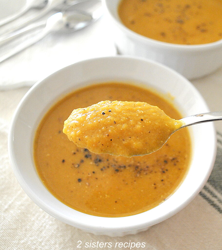A spoonful of pureed butternut and red lentil soup.
