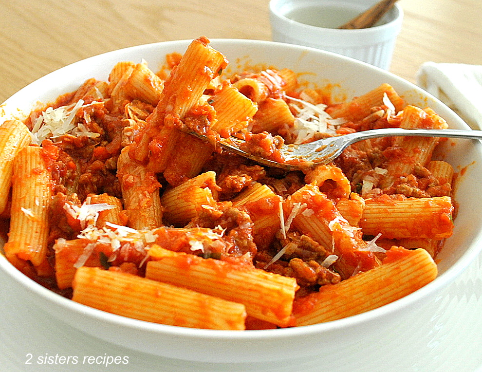 A forkful of rigatoni pasta with Lamb Bolognese.